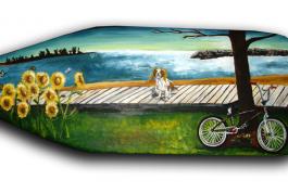a paddle with a dog, bike, and sunflowers